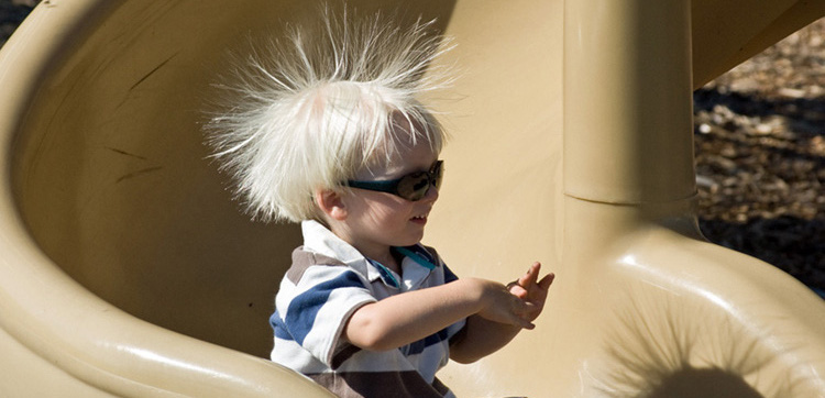 Static charge on hair caused by rubbing on a slide